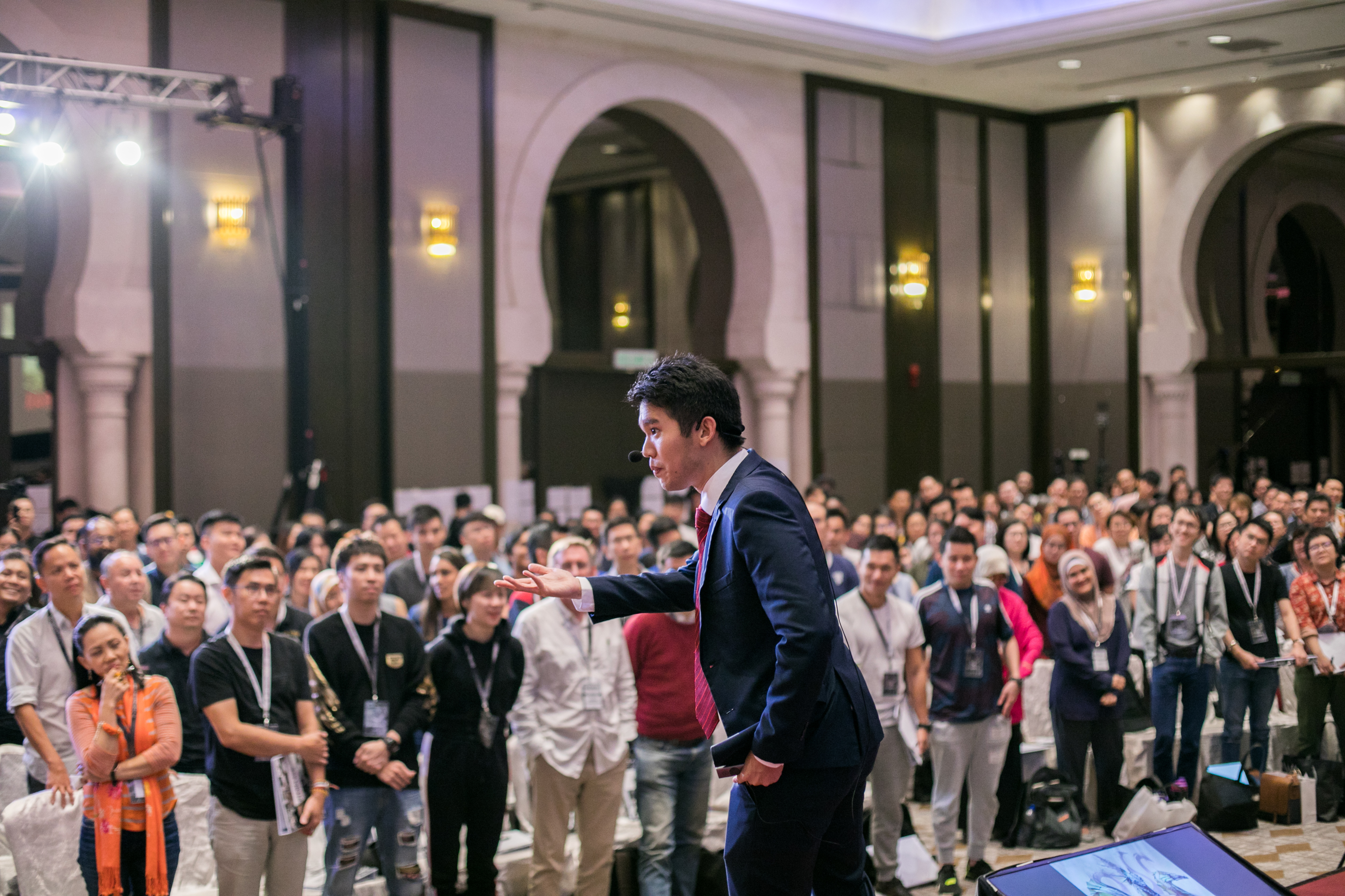 Michael Teoh engaging a standing crowd at a conference